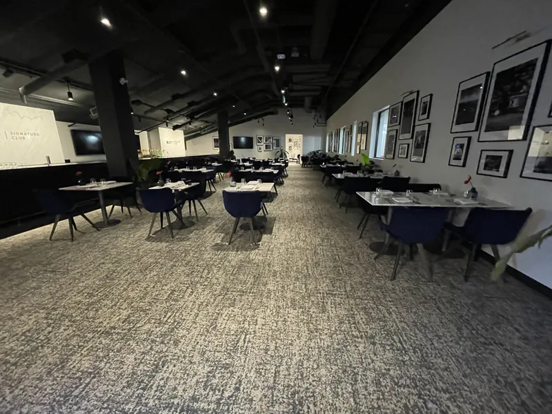 The Signature Club dining room set for service